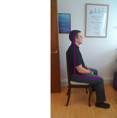 man sitting correctly in his office chair